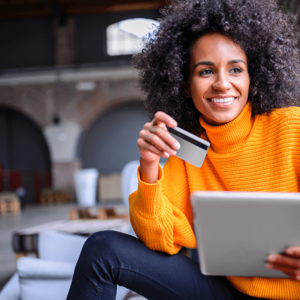 A woman smiling and banking online.| Purely Write